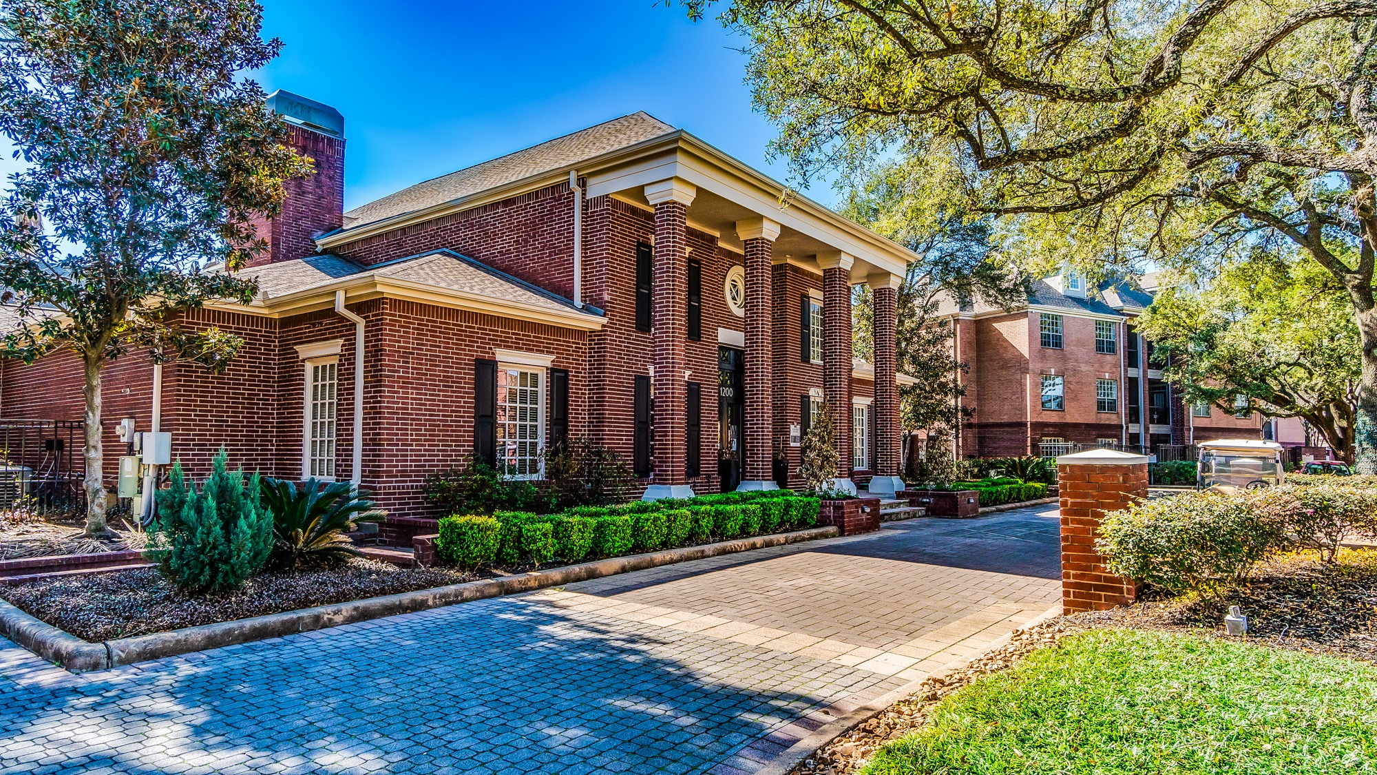 A red brick building with a white door and windows.